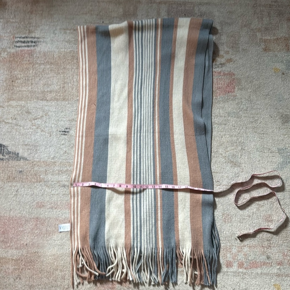 Knit fringed scarf.